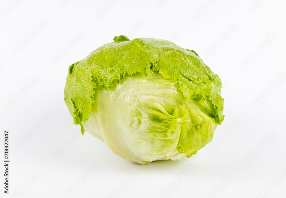 A head of green iceberg lettuce on a white background. Fresh green salad. A head of green iceberg lettuce on a white background. Fresh green salad.