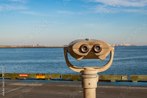 Boston, MA, US-December 8, 2023: Public viewing binoculars looking out onto Boston Harbor and Logan Airport.