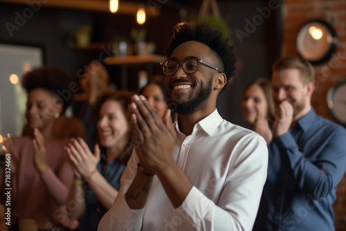 An image capturing the moment of employee recognition with colleagues applauding and celebrating a standout team member. Focus on the joy and appreciation in their expressions, Business team clapping. photo