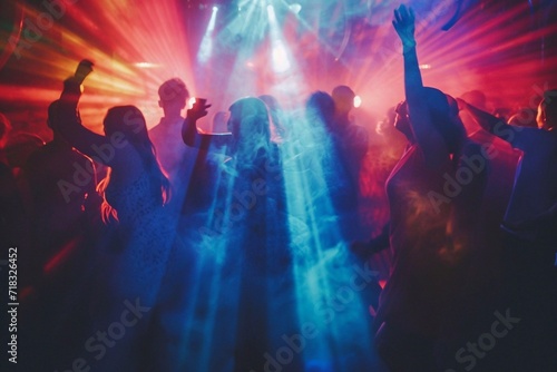 Young people dancing and having fun in a nightclub during a music festival. Crowd at concert photo