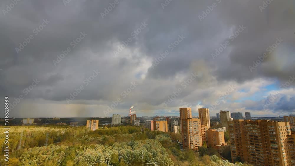 The clouds run over the park and the area of the modern city The clouds run over the park and the area of the modern city