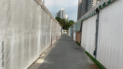 Bangkok, Thailand - First person point of view shot walking towards empty small alley at retail stall at JODD FAIRS DanNeramit. Closed shop concept photo