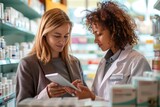 A pharmacist assists a customer with information on her tablet in a pharmacy