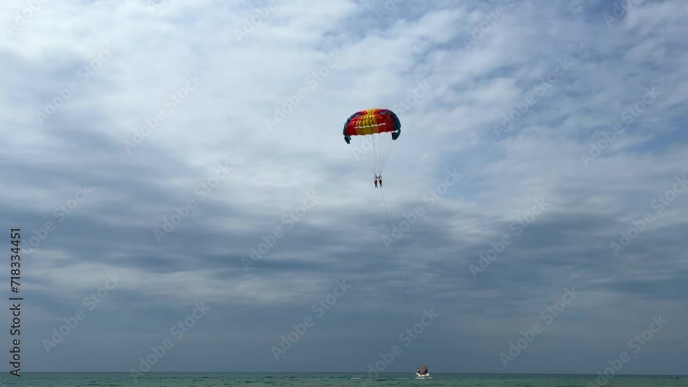 Parasailing: a boat with a marine parachute on the waves. The concept of a cloudy landscape, freedom and summer. Parachutists over the surface of the Black Sea against the sky on a summer day. 4K Parasailing: a boat with a marine parachute on the waves. The concept of a cloudy landscape, freedom and summer. Parachutists over the surface of the Black Sea against the sky on a summer day. 4K