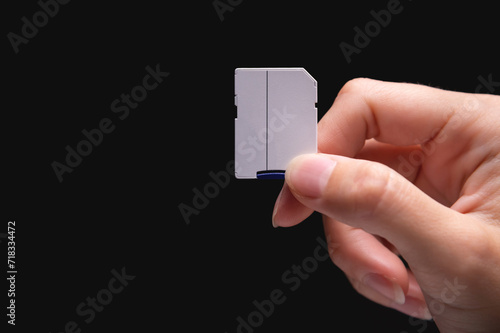 New fast micro SD memory cards and SD card adapter in hand on black background