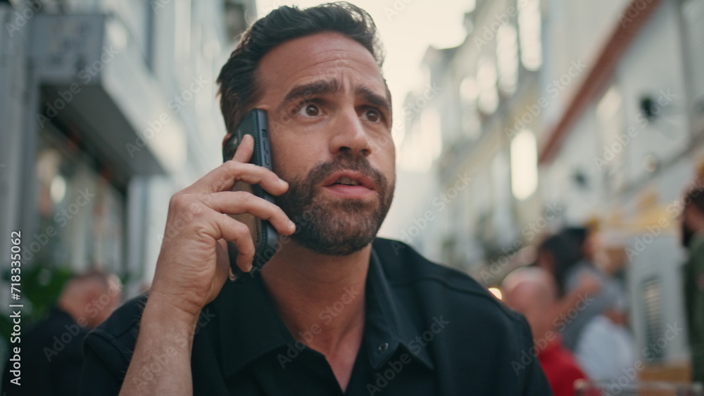 Furious man quarrelling cellphone call at city closeup. Guy ending conversation Furious man quarrelling cellphone call at city closeup. Guy ending conversation