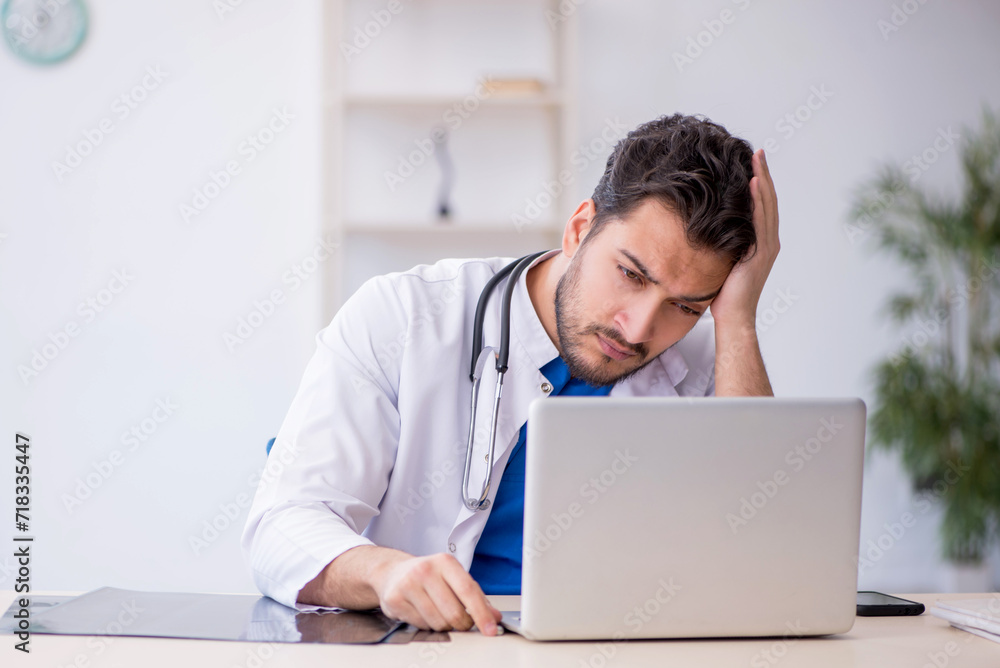 Young male doctor in telemedicine concept Young male doctor in telemedicine concept