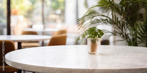 White marble table top in a blurred cafe or restaurant interior.