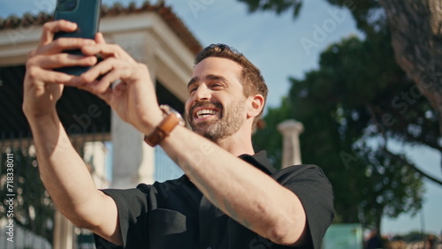 Happy guy talking phone camera on city street close up. Cheerful man video call