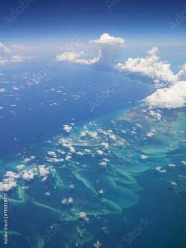 Beautiful aerial view of the Caribbean islands, turquoise seas and mesmerizing clouds from a plane. 