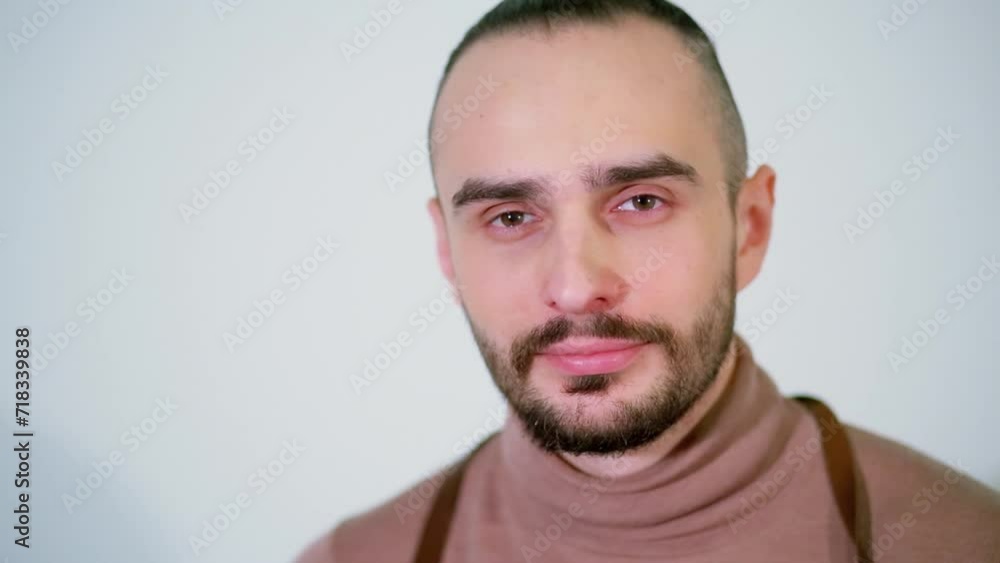 Face of bearded man gazes at studio with white background Face of bearded man gazes at studio with white background