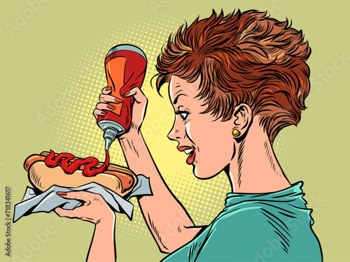 Delicious fast food and street food for all customers. A girl with a big appetite pours ketchup on a hot dog. Unhealthy food, but very tasty. Pop Art Retro