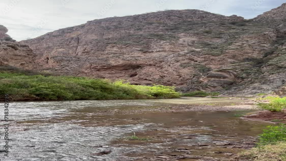 River in Valle Desértico, sunny day, sky with clouds, Jachal and Huaco in San Juan, Argentina, orientation as horizontal River in Valle Desértico, sunny day, sky with clouds, Jachal and Huaco in San Juan, Argentina, orientation as horizontal
