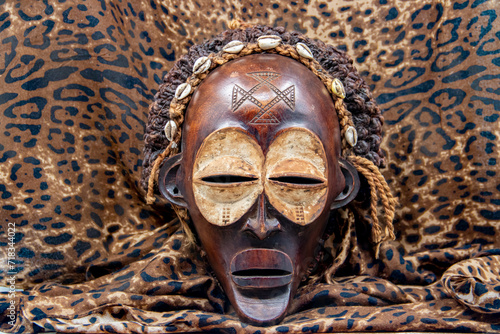 Wooden tribal African mask from Uganda, for family or personal protection, made of local wood, ropes and seashells as hair decoration