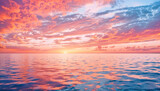 A vibrant sunset with a mix of orange pink and blue clouds reflecting on the ocean water