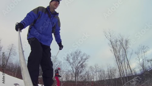 Man skier down slope and makes selfie in ski resort at winter photo