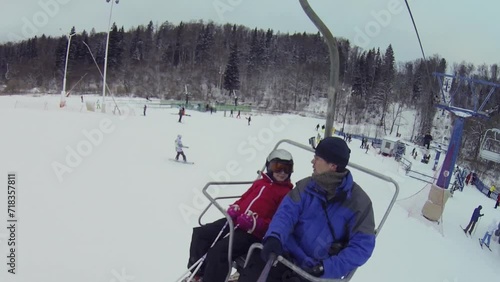 Man with daughter makes selfie on cableway in ski resort photo