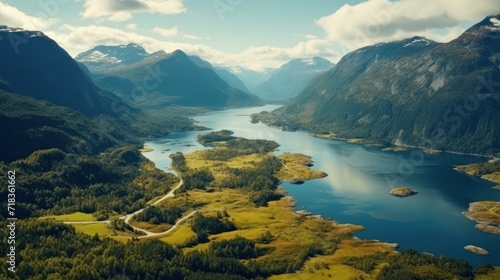  an aerial view of a mountain lake surrounded by green trees and a blue sky with white clouds in the background.