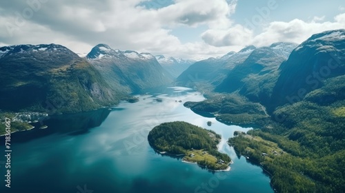  an aerial view of a large body of water with mountains in the background and trees in the foreground and a body of water in the foreground.
