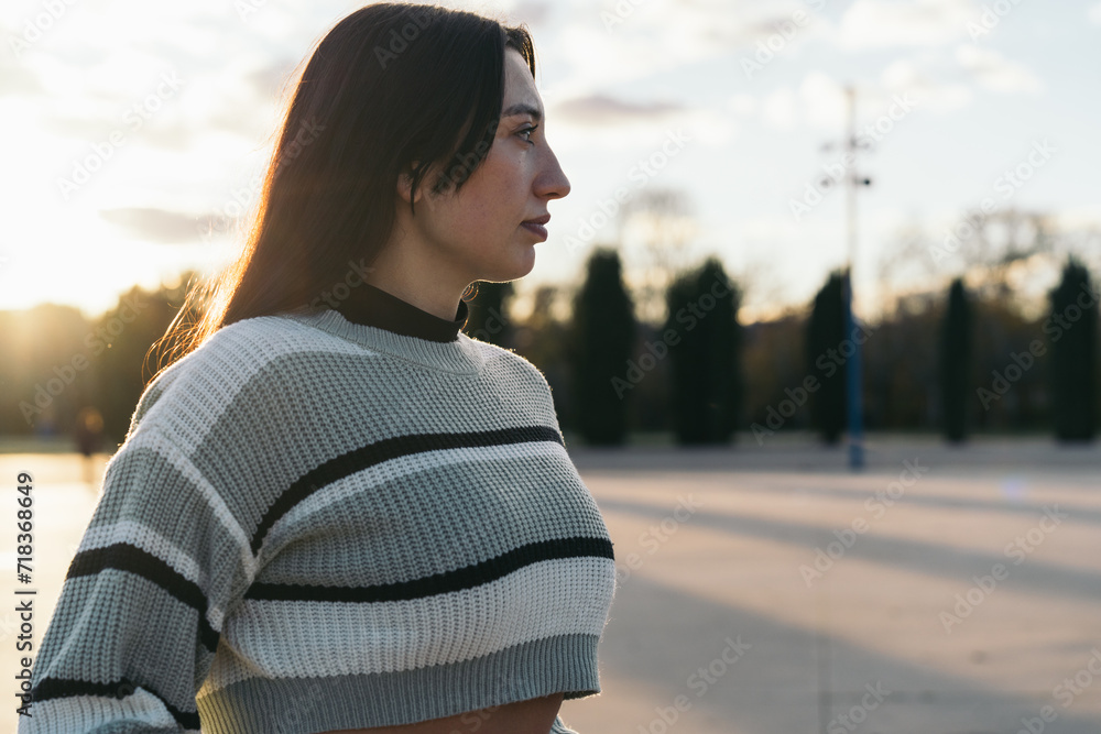 Serene Hispanic Young Woman in Thoughtful Gaze. Portrait of a serious young Hispanic woman, lost in thought, looking away from the camera. Serene Hispanic Young Woman in Thoughtful Gaze. Portrait of a serious young Hispanic woman, lost in thought, looking away from the camera.