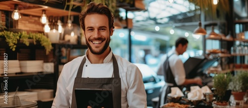 A Restaurant entrepreneur with tablet standing and a smile to customers.Generate AI image photo