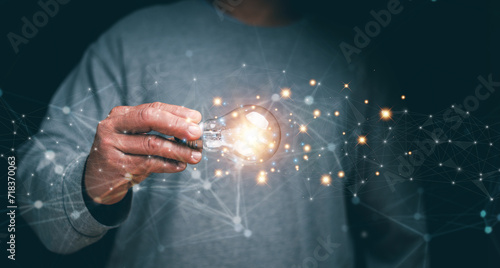 Businessman holding light bulb creative connection of futuristic technology internet network, New creativity and innovation are keys to business successful, Thinking and creative concept, Planning.