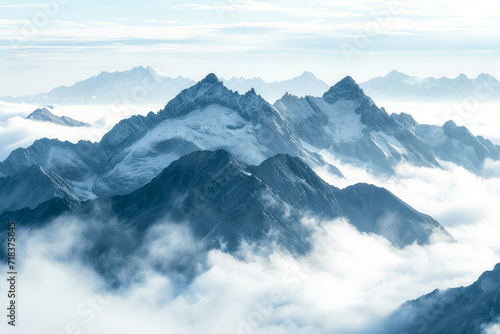 majestic mountain range rises above a sea of clouds, its peaks adorned with intricate patterns of snow and ice © mila103