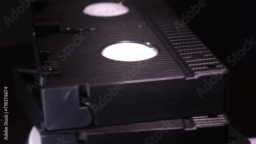 Retro VHS tapes turning in place, physical media concept photo