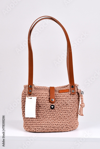 Women s retro checkered brownish bink handbag with price tag on white background
