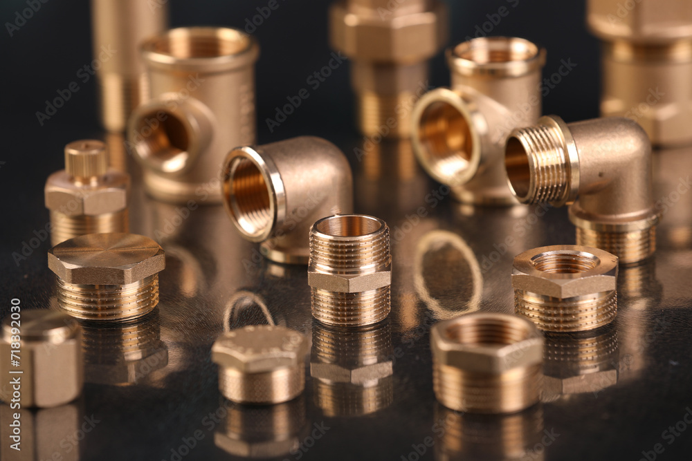 A set of metal and copper water pipe parts, a water wrench and pipe elbows, blue and red colors, black background, different shapes and different sizes A set of metal and copper water pipe parts, a water wrench and pipe elbows, blue and red colors, black background, different shapes and different sizes