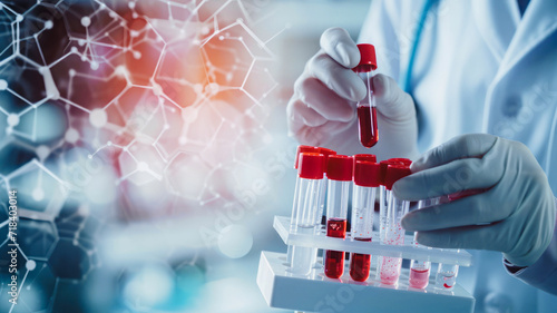 A scientist holds test tubes and vials containing blood cells and a virus treatment, utilizing biotechnology and DNA genome sequencing in a holographic display.