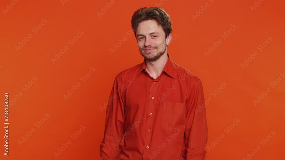 Okay. Happy Caucasian man looking approvingly at camera showing ok gesture like sign positive feedback, approve something good celebrate victory wink blink eye flirting. Young guy on orange background Okay. Happy Caucasian man looking approvingly at camera showing ok gesture like sign positive feedback, approve something good celebrate victory wink blink eye flirting. Young guy on orange background