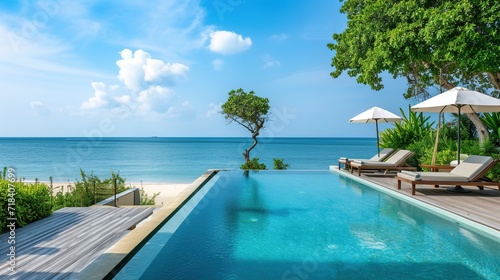 Luxury swimming pool on the beach © Doni_Art
