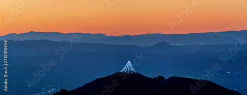 Panoramic view of mountain  lights  at sunrise  sunset  silhouetted  Christmas light  tree  