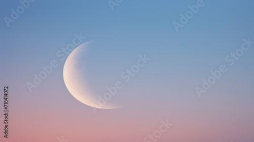  a half moon is seen in the sky with a pink and blue sky in the foreground and a pink and blue sky in the background.
