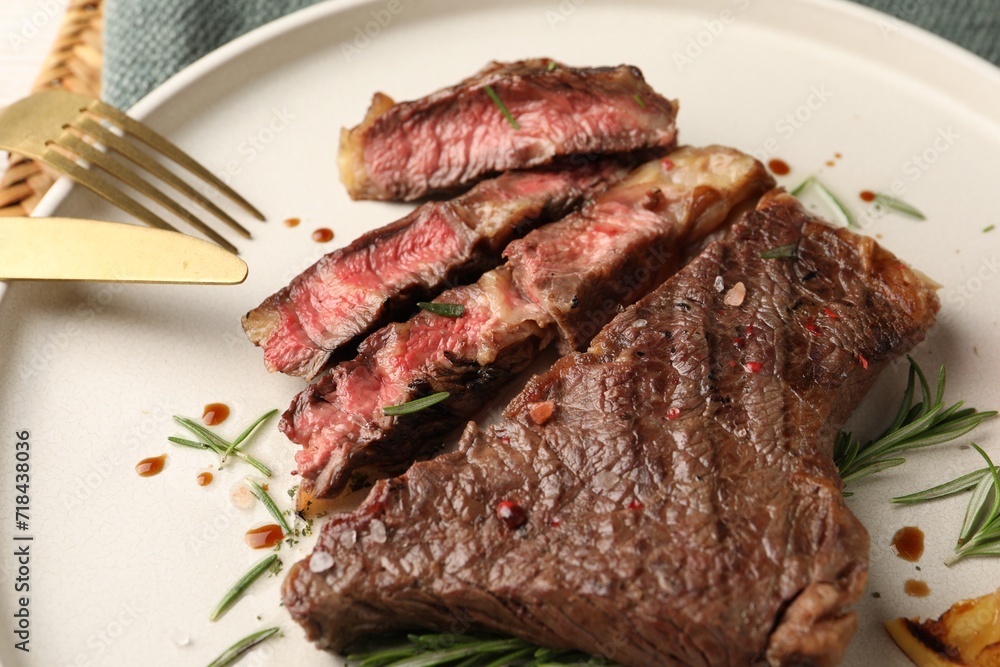 Delicious grilled beef steak and rosemary on plate, closeup Delicious grilled beef steak and rosemary on plate, closeup