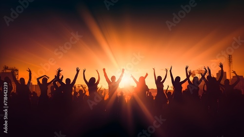 Silhouette of large group of people dancing outdoor at music festival