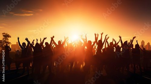 Silhouette of large group of people dancing outdoor at music festival