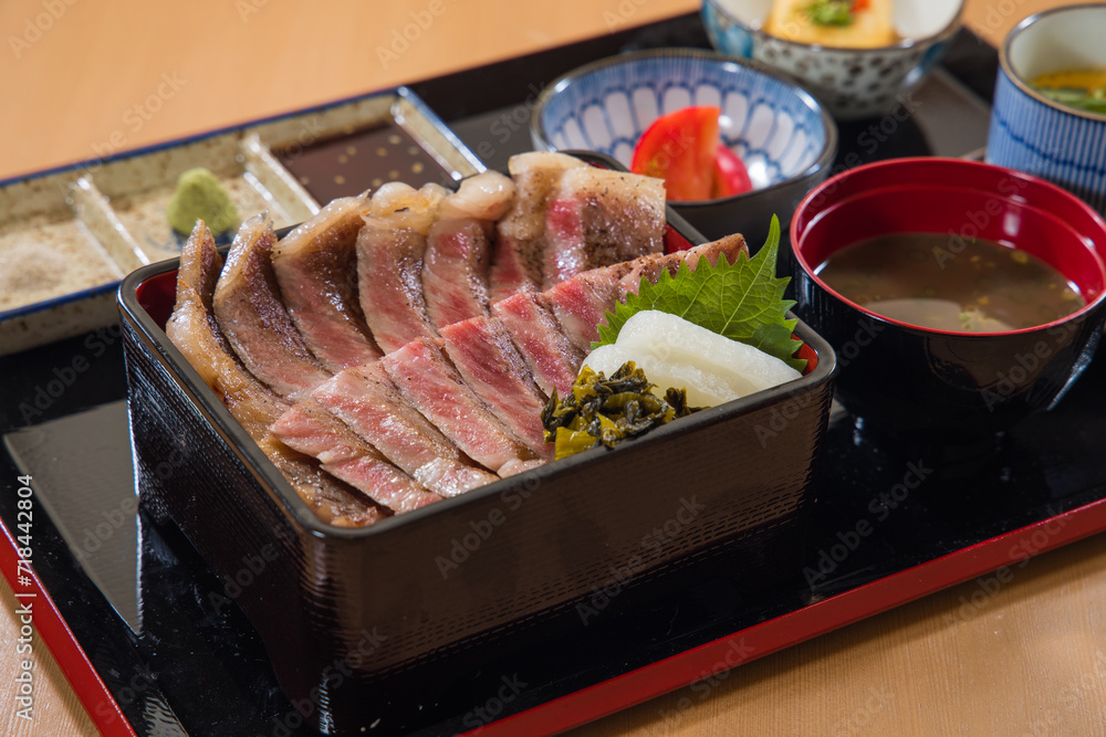 japanese cuisine. roasted wagyu beef on black plate japanese cuisine. roasted wagyu beef on black plate
