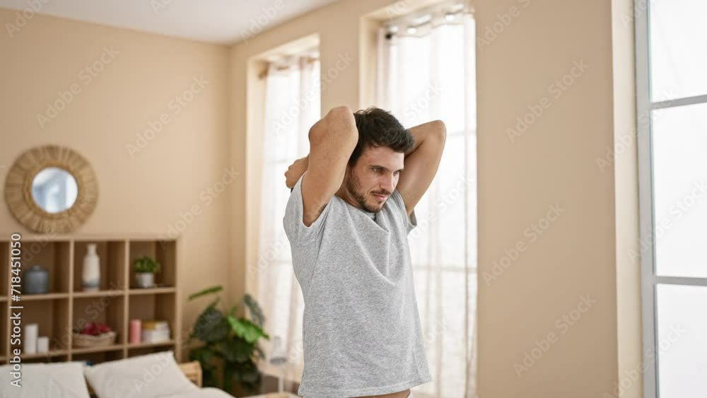 Handsome hispanic man exercising with dumbbells in a stylish living room. Handsome hispanic man exercising with dumbbells in a stylish living room.