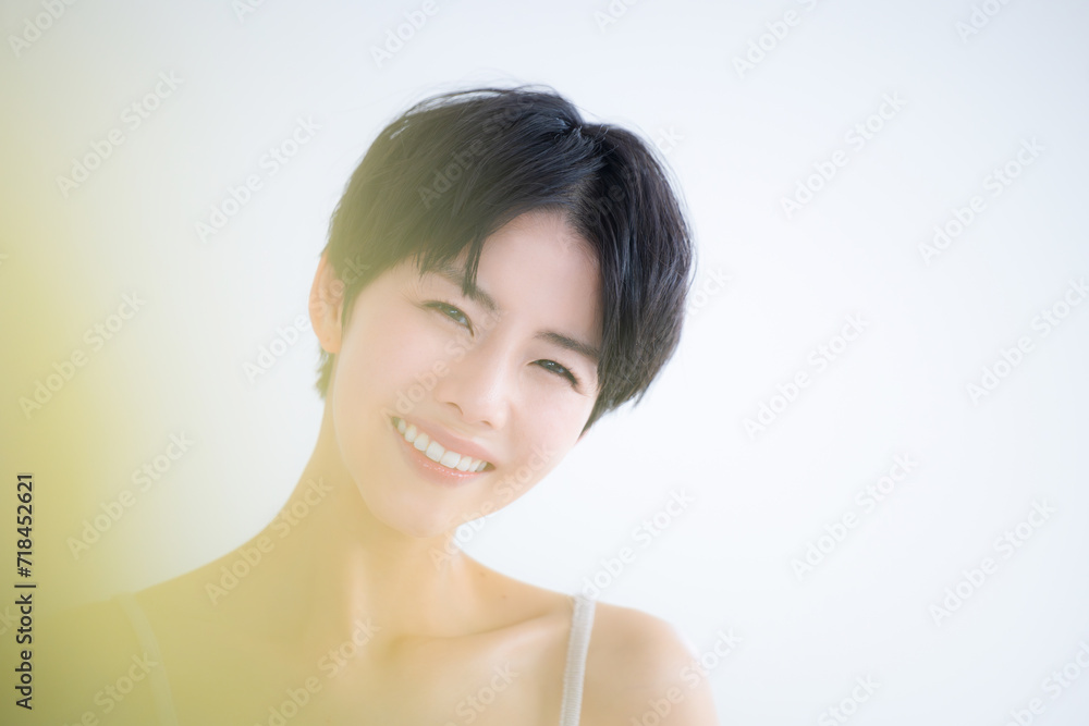 Spring Cute yellow foreground blurred smile beauty image Cute Asian (Japanese) woman close up looking at camera Spring Cute yellow foreground blurred smile beauty image Cute Asian (Japanese) woman close up looking at camera