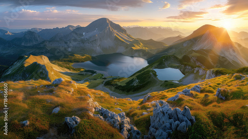Beautiful mountains with lake under the warm light of a stunning sunrise