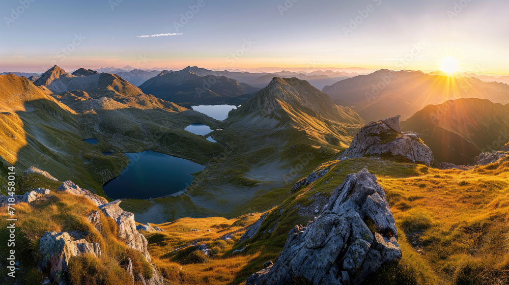 Beautiful mountains with lake under the warm light of a stunning sunrise