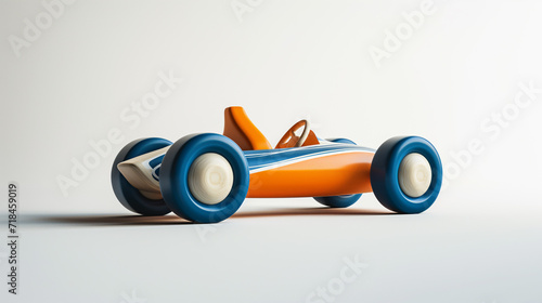 retro wooden toy racecar with blue, white and orange colors on a white background. © Michael
