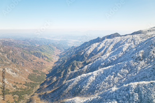 Beautiful aerial view of snow covered pine forests. Rime ice and hoar frost covering trees. Scenic winter landscape of Baizhangling  Lin an  Hangzhou  Zhejiang  China. Drone landscape in winter.