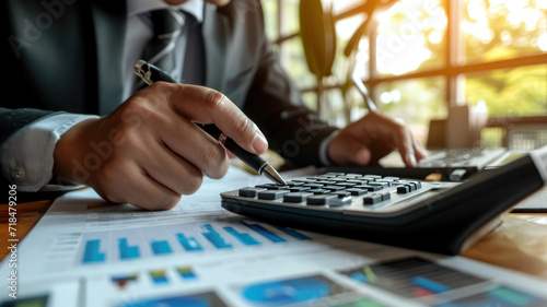 businesswoman working on desk office with using a calculator to calculate the numbers, finance accounting concept