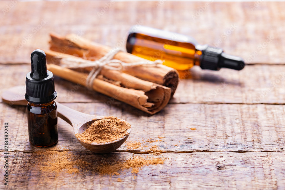 Splinters, powder and essence of cinnamon, on the old table Splinters, powder and essence of cinnamon, on the old table