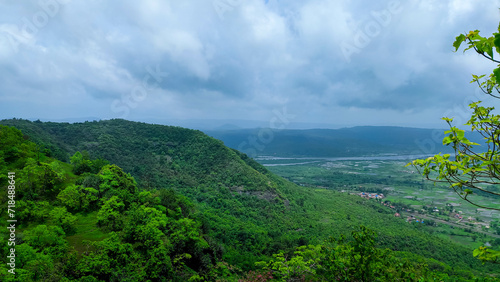 beautiful view of the mountain and rainy cloudy sky from the top of the avachitgad fort in maharashtra in India. photo