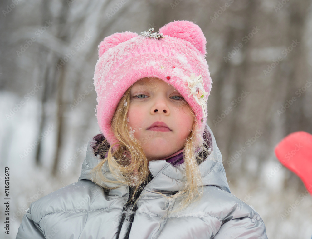 A girl in a snowy park. Photo of a child in a winter forest. Winter, winter holidays, vacations, vacations. A girl in a snowy park. Photo of a child in a winter forest. Winter, winter holidays, vacations, vacations.