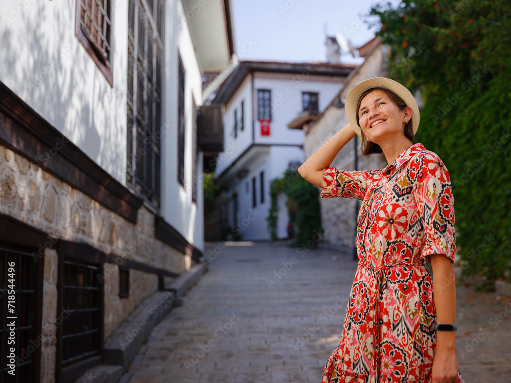 female summer travel to Antalya, Turkey. young asian woman in red dress walk through old town Kalechi , female tourist traveler discover interesting places and popular tourist attraction female summer travel to Antalya, Turkey. young asian woman in red dress walk through old town Kalechi , female tourist traveler discover interesting places and popular tourist attraction